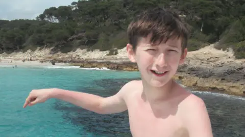 Arthur Family Liam on a family holiday about to jump in the sea