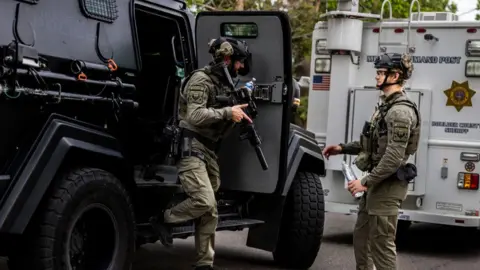 Tactical teams get into position following an incident in Colorado