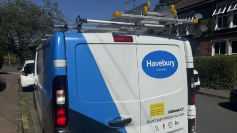 George King/BBC A white and blue van photographed from behind. It has the Havebury Homes logo on it. 