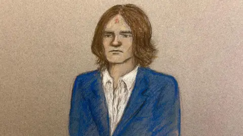 Julia Quenzler A court sketch of Mckenzie Morgan. He is wearing a blue suit and with hair that is longer than in the mugshot, this time reaching his shoulders.