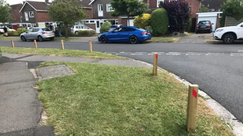 LDRS Parking wooden posts in use close to The Manor Park School to stop parking on vergess