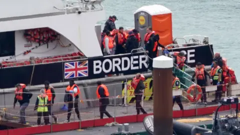 PA Media Migrants arriving in Dover