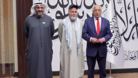 Coyle with two officials after his release. 