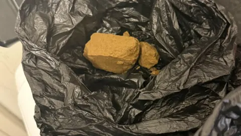 Greater Manchester Police A black bin bag with a large quantity of drugs seized by police.
