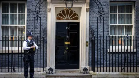 Police officer stands outside 10 Downing Street
