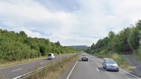 A dual carriageway with cars on it. 