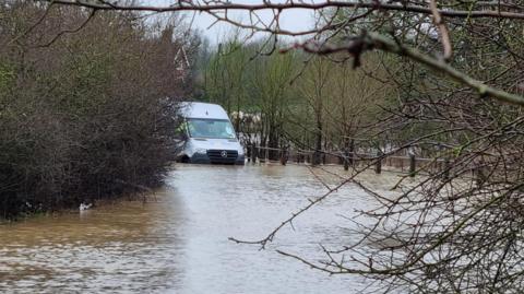 Minibus stuck in floodwater