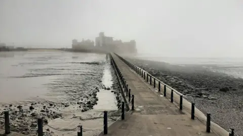 WeatherWatchers/The Cleeve Rambler Weston-super-Mare pier shrouded in fog against a grey sea.