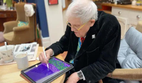 PA Media David Hockney creating Christmas-themed artwork which is displayed at Battersea Power Station in London. Saturday December 2, 2023.