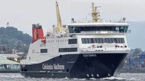 A large black and white ship with red funnels