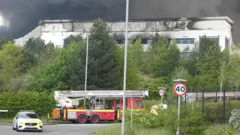 Richard Pursehouse Police and fire open air the scorched building