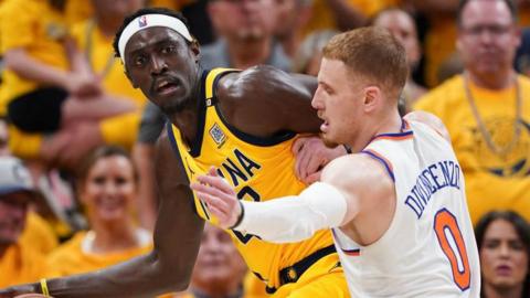 Pascal Siakam of the Indiana Pacers holds off Donte DiVincenzo of the New York Knicks