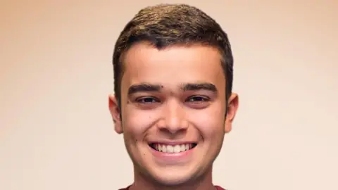 Pedro Ballester has brown curly hair