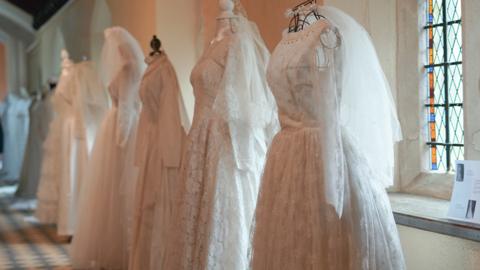 A row of 8 wedding dresses 