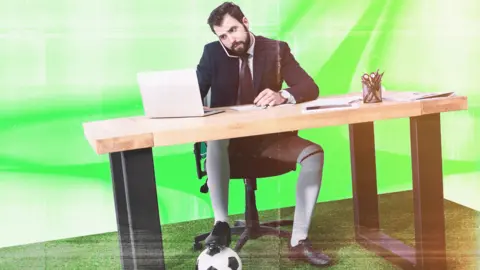 BBC A creative graphic of a man sitting at a desk wearing a suit and tie on his top half and shorts, knee high white socks and footbll boots on his bottom half. He is simultaneously taking a phone call while working on his laptop with a football under one foot.