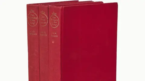Sotheby's A set of 3 red volumes of The Lord of the Rings.