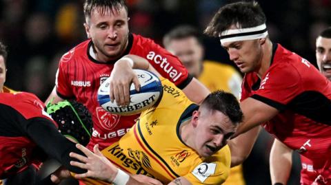 Ulster's James Hume is tackled by Toulouse pair Francois Cros and Alexandre Roumat 