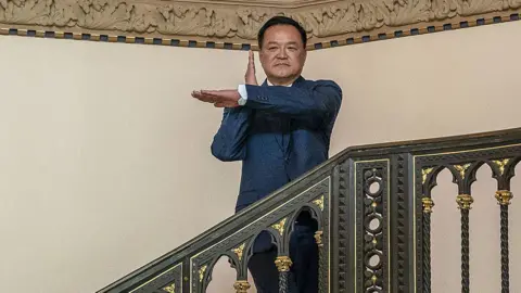 AFP via Getty Images Thai Prime Minister Anutin Charnvirakul poses as he arrives at the Government House in Bangkok on February 9, 2026