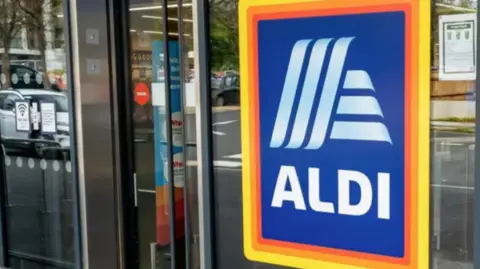 The entrance to an Aldi supermarket with the store's bright Aldi sign prominently displayed