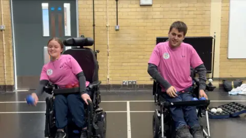 SophIie Newnham and Louis Saunders playing boccia in a sports hall in Surbiton.