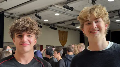 Zac Sherrat/BBC Two boys, one has curly brown hair and one has curly blonde hair.