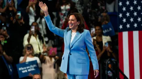 Getty Images Harris at an event in Atlanta waves to the crowd