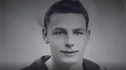 Family photo A black and white photograph of John Dennett as a young man in his Royal navy uniform
