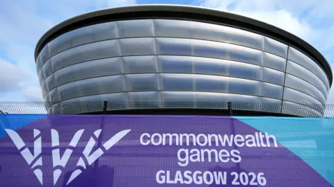 PA Media A futuristic silver arena with a purple Commonwealth Games Glasgow 2026 banner in the foreground