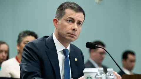 Getty Images Pete Buttigieg sits in front of microphone