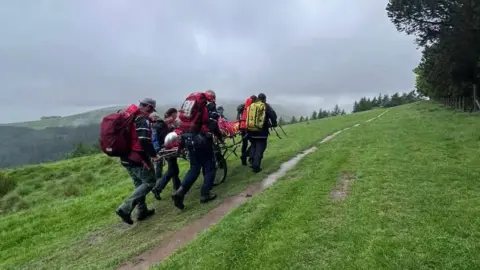 Edale Mountain Rescue Team The rider being stretchered away from the scene