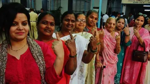 Getty Images During the Municipal Corporation general elections in Thane at Kisan nager voting centre, women seen showing the ink mark on their fingers after casting their votes, on January 15, 2026 in Mumbai, India.