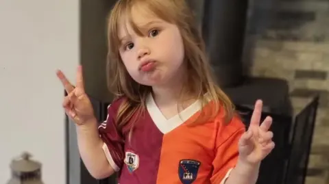 Family photo Reayah wearing her two-tone Galway/Armagh GAA top