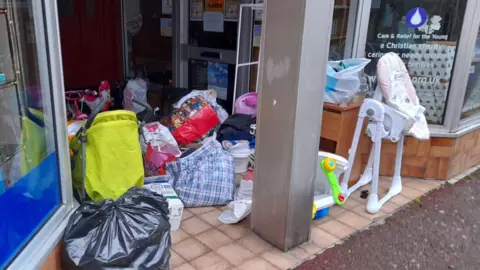 CRY Jersey Bags cover the floor in front of the shop entrance of CRY Jersey.
