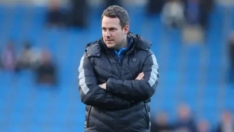 Getty Images James Rowe wore a big coat during his tenure at Chesterfield FC