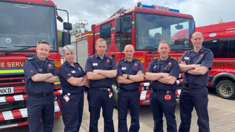 Northumberland Fire and Rescue Service staff in front of fire engines