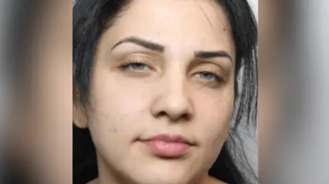 GMP A mug shot of Agita Cica. She has long dark hair and is looking into the camera.