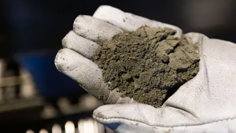 Getty Images Copper concentrate in a gloved hand