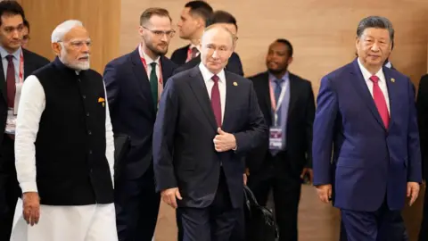 Getty Images O primeiro -ministro indiano Narendra Modi, o presidente russo Vladimir Putin e o presidente chinês Xi Jinping frequentam uma foto de família durante a cúpula do BRICS em Kazan em 23 de outubro de 2024.