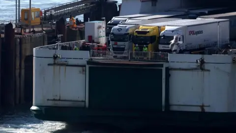 EPA Lorries wait to disembark a ferry at the Port of Dover in England