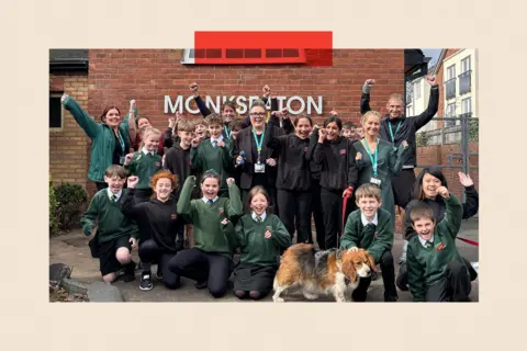 Children and staff with a pet dog in a group photo at Monkseaton school 