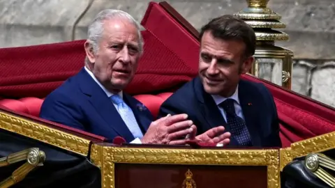 King Charles III (left) and French President Emmanuel Macron ride in a carriage at Windsor Castle. Photo: 8 July 2025