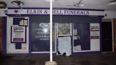 CPS/Hampshire & Isle of Wight Constabulary The front of Elkin and Bell Funerals premises - there are signs advertising direct cremations and "simple and bespoke services"
