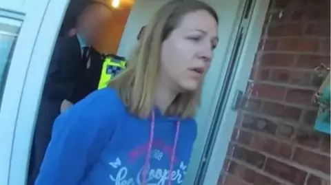 Cheshire Constabulary Lucy Letby, pictured in a blue top, during her arrest at her home in 2018.