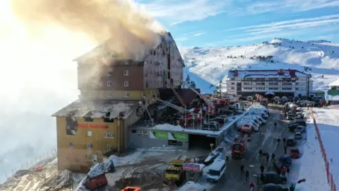 Getty Images A view of the area as firefighters respond to a fire that broke out at a hotel at the Bolu Kartalkaya Ski Center, on January 21, 2025 in Bolu, Türkiye. The death toll in the fire rose to 10 and the number of injured to 32.