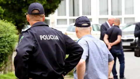 Getty Images Bosnian police secure the area after a shooting at an elementary school in the northeastern Bosnian city of Lukavac on June 14, 2023. 