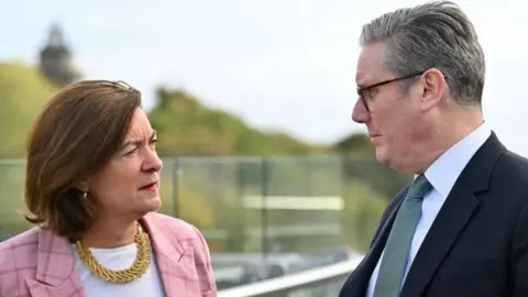 Eluned Morgan and Sir Keir Starmer stood at Queen Elizabeth House in Edinburgh, Scotland.