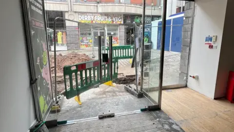 ALB Group View from shop showing doorway and roadworks beyond