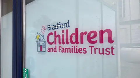 BBC Bradford Children and Families Trust sign on its building window