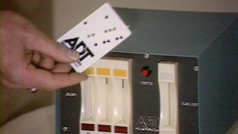 A hand holds a punch hole keycard.
