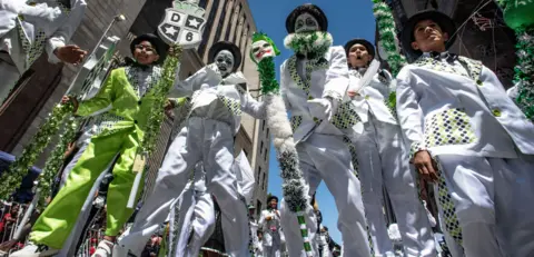 EPA A group of five people wearing white and green suits participate in the Tweede Nuwe Jaar festival - Saturday 4 January 2025